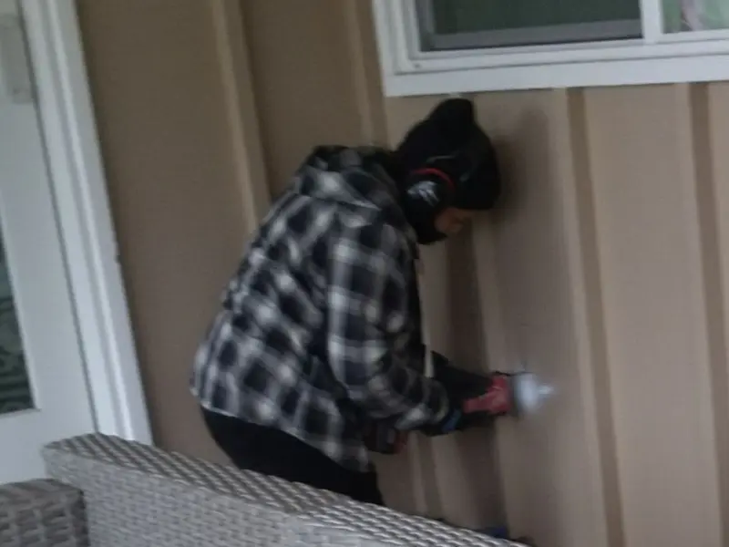 Professional electrician installing an exterior outlet in Crofton